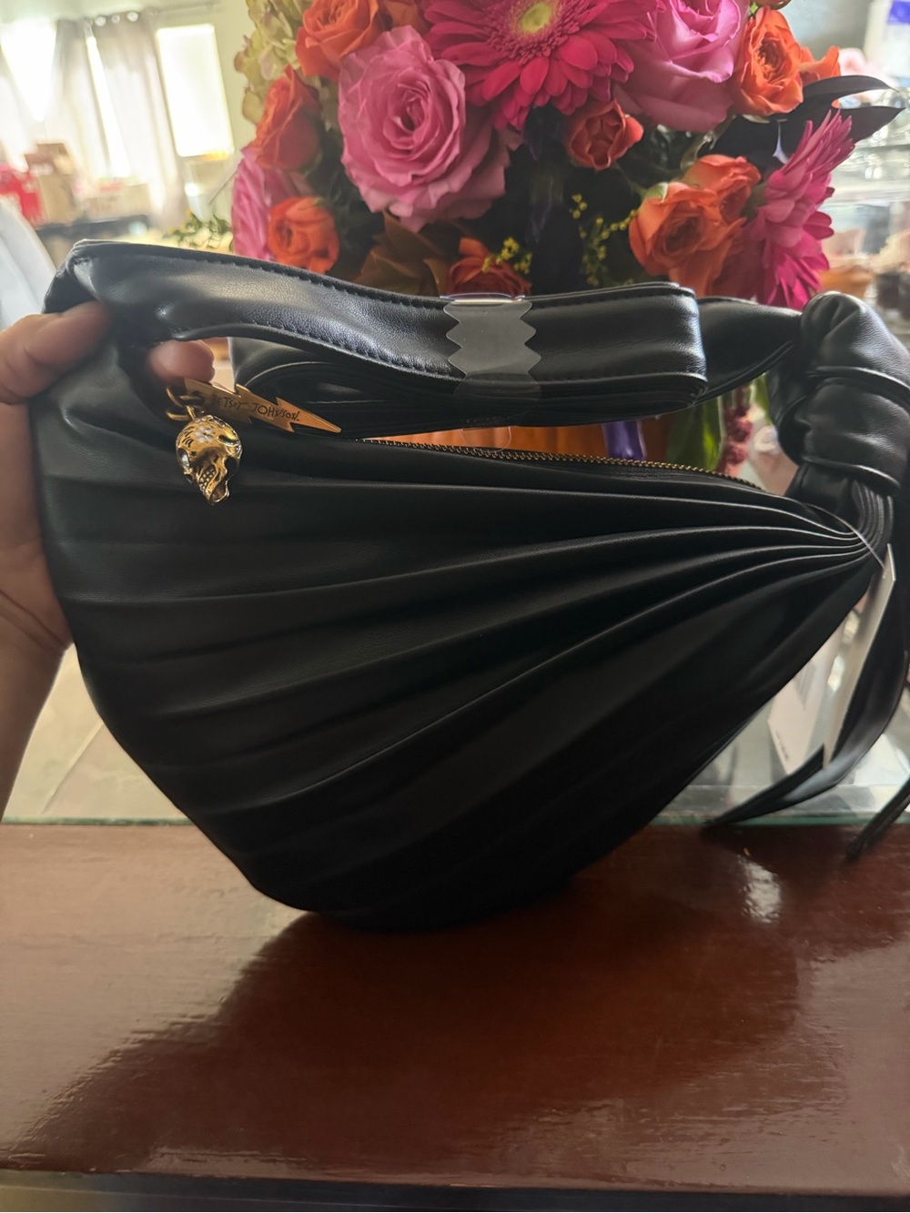 Betsey Johnson’s Black Sculpted Leather Shoulder Bag with Gold Accent